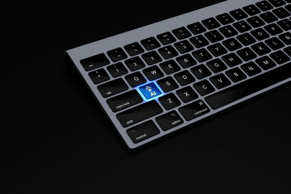 a black keyboard with a blue button on it